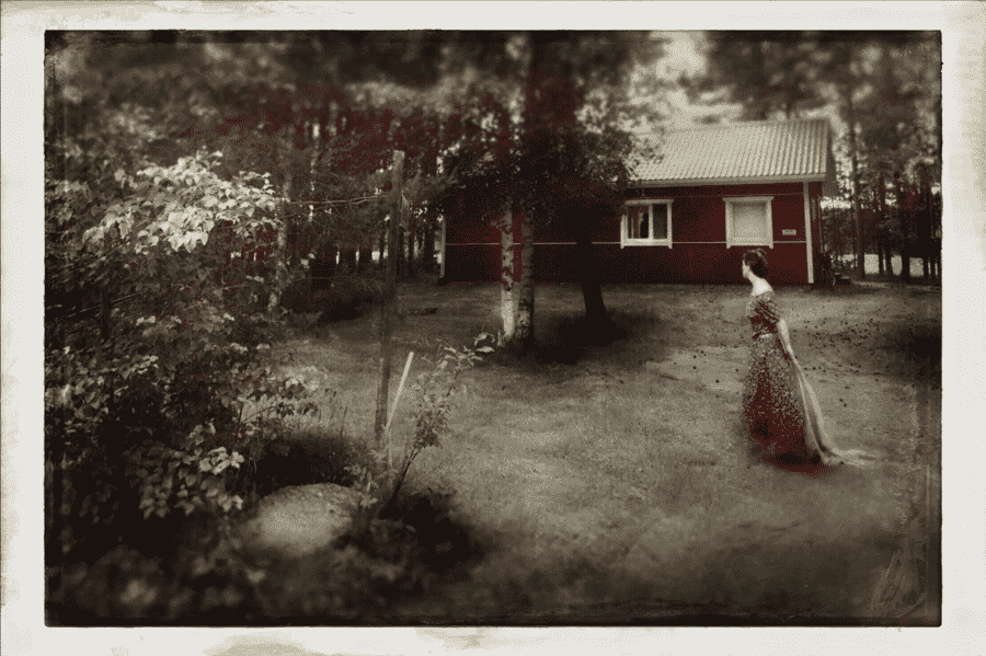 Ana Priscila Rodriguez photograph of woman in woods and red cabin