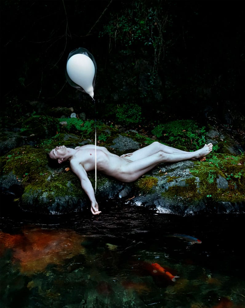 Diego Orlando painting of man lying next to river