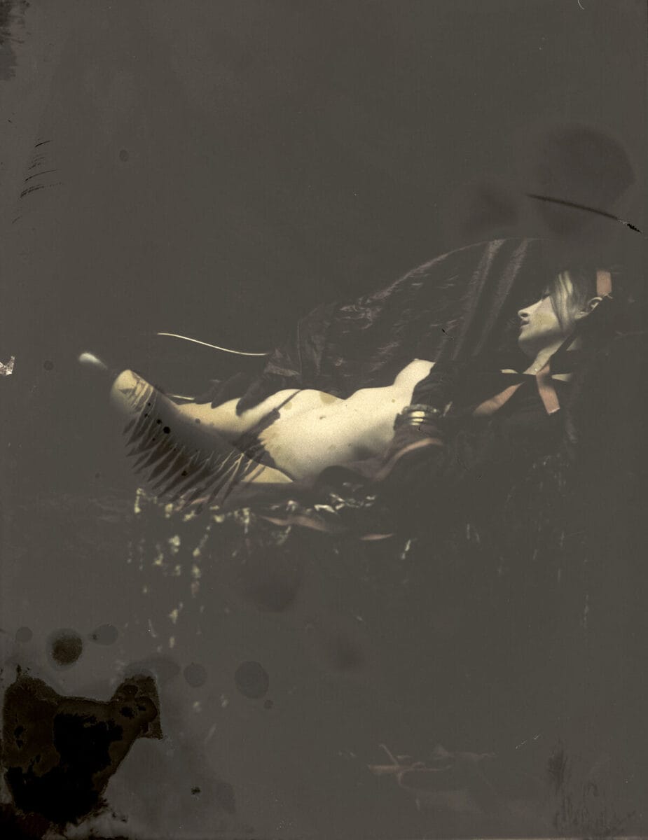 Black and white photograph of half-naked reclining woman by Jeremy Mann