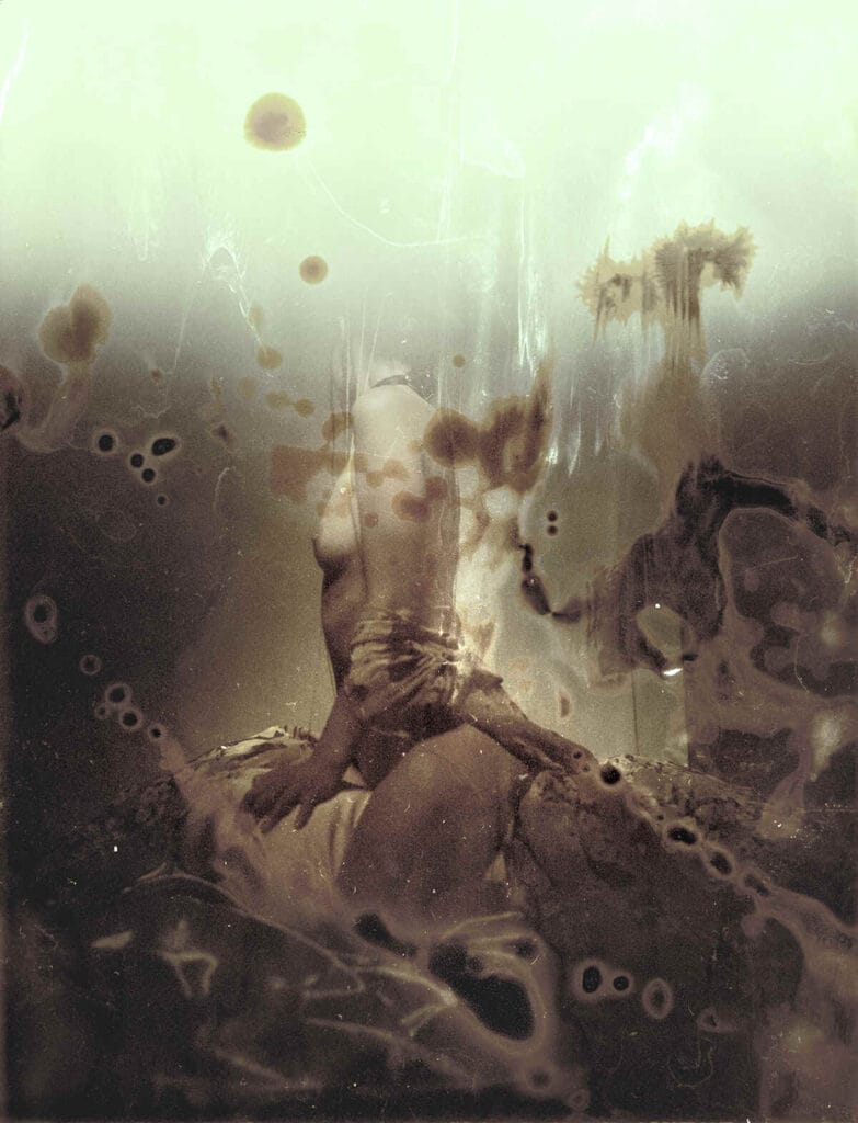 Abstract sepia photograph of a woman with her head turned to the camera by Jeremy Mann