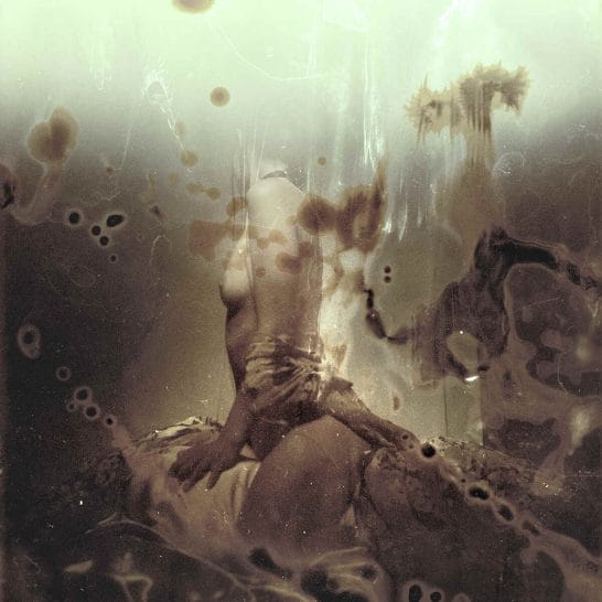 Abstract sepia photograph of a woman with her head turned to the camera by Jeremy Mann